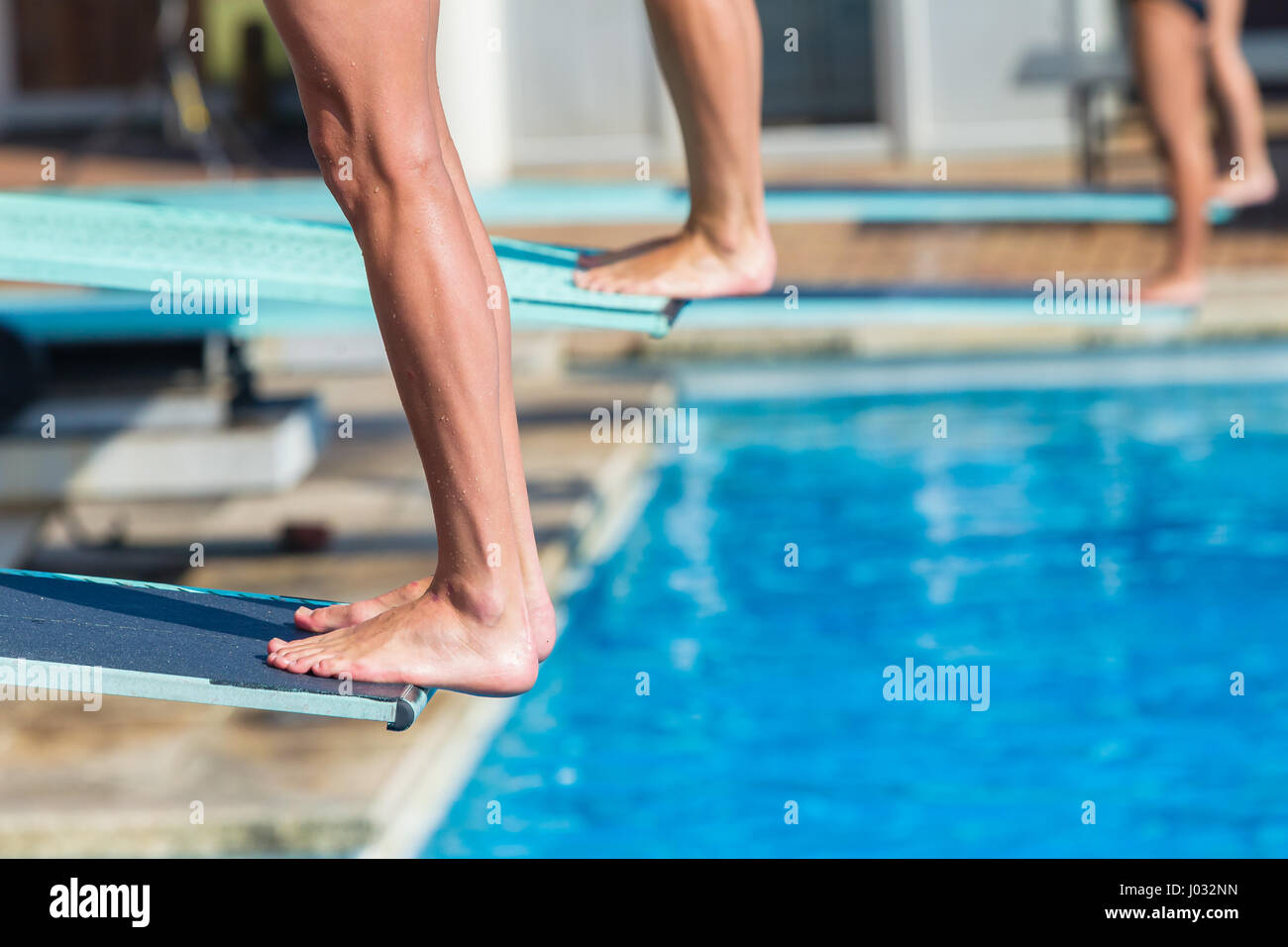Aquatic diving pool divers feet edge of board for backflip into