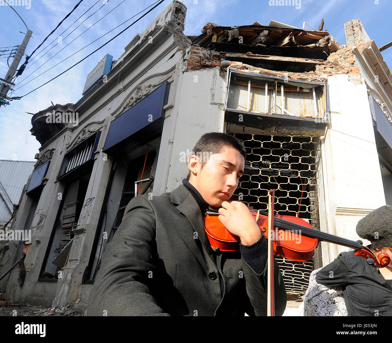 Alex Moreno plays his violin during a benefit for the Talcahuano children's orchestra in Talcahuano, Chile following the 2010 tsunami and earthquake. Stock Photo