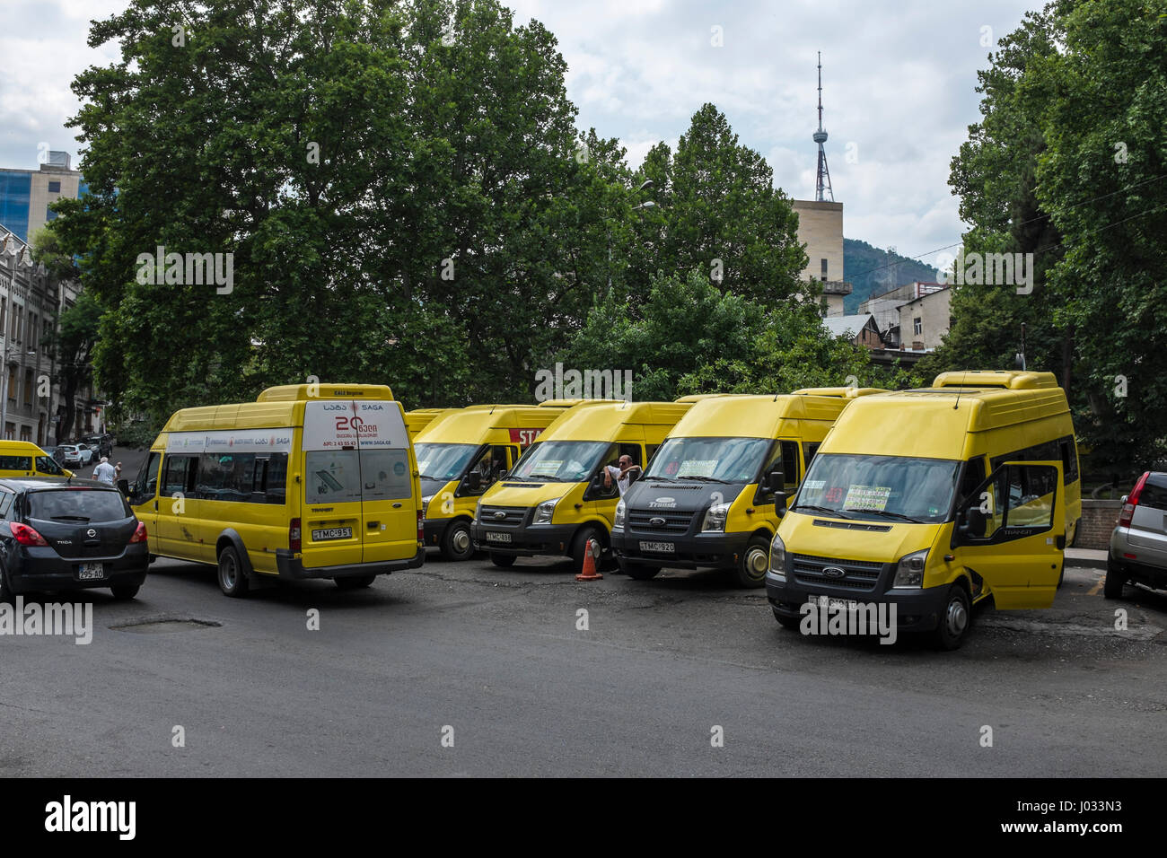 Row of yellow minibuses parked in Tbilisi, Georgia, Eastern Europe. Stock Photo