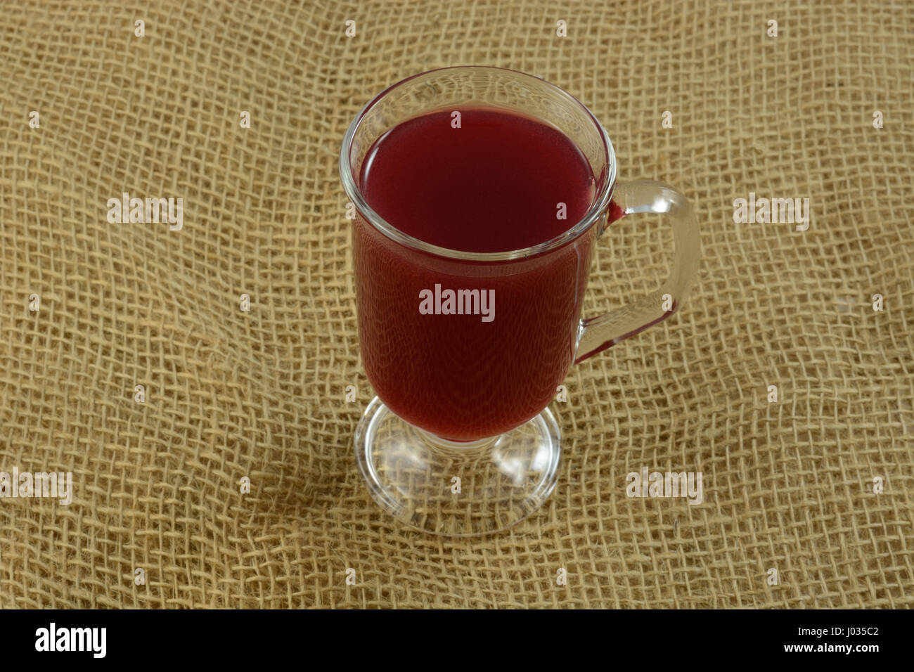 Cherry juice cider in glass on burlap Stock Photo Alamy