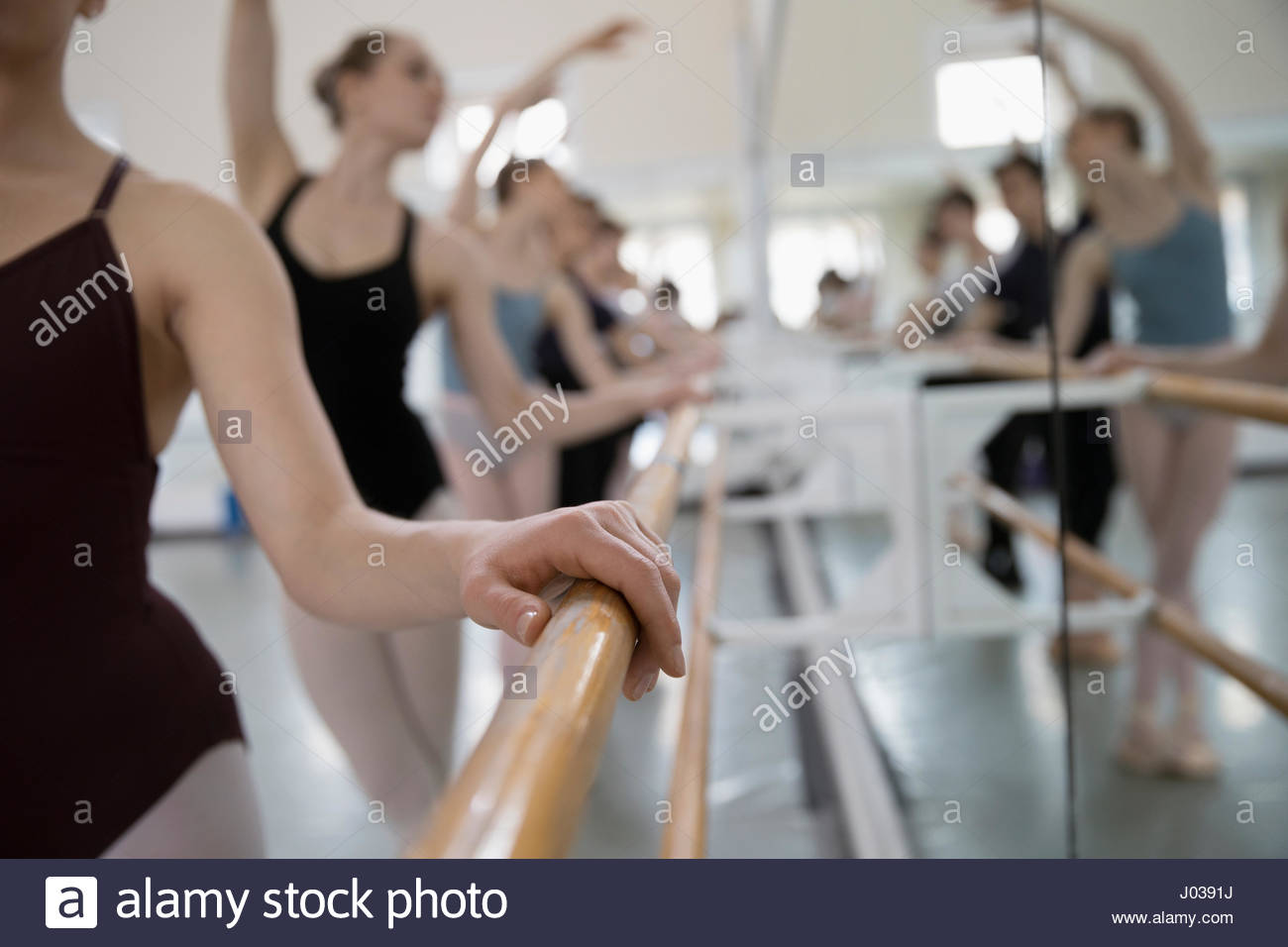 Ballet dancers practicing at barre in dance studio Stock Photo Alamy