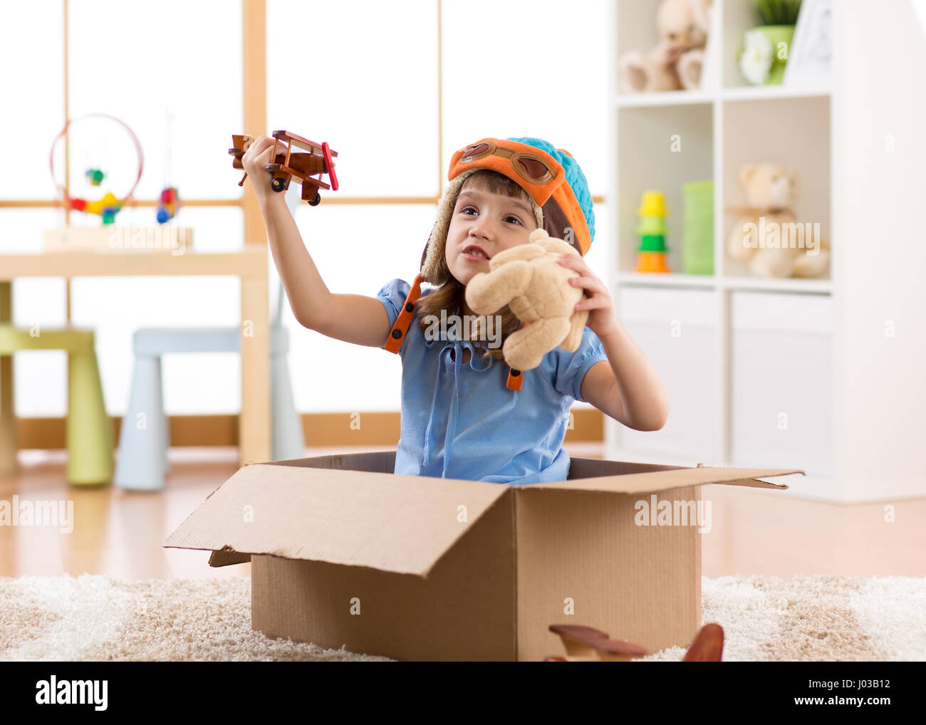 Kid child pilot flying a cardboard box Stock Photo