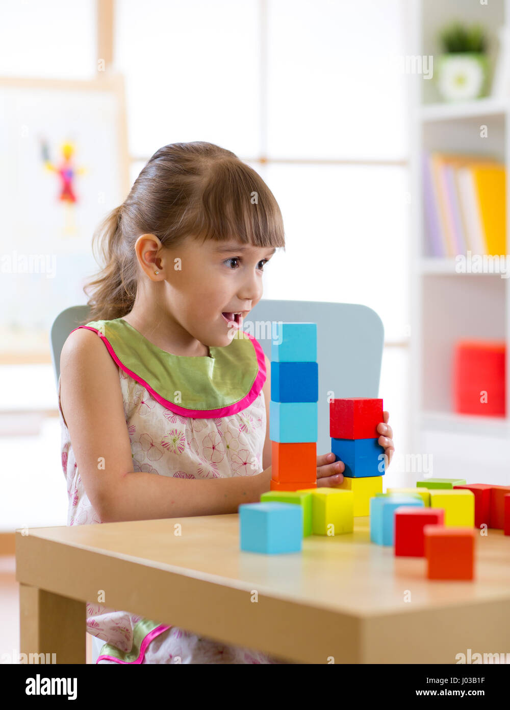 kid little girl playing wooden toys at home or kindergarten Stock Photo ...