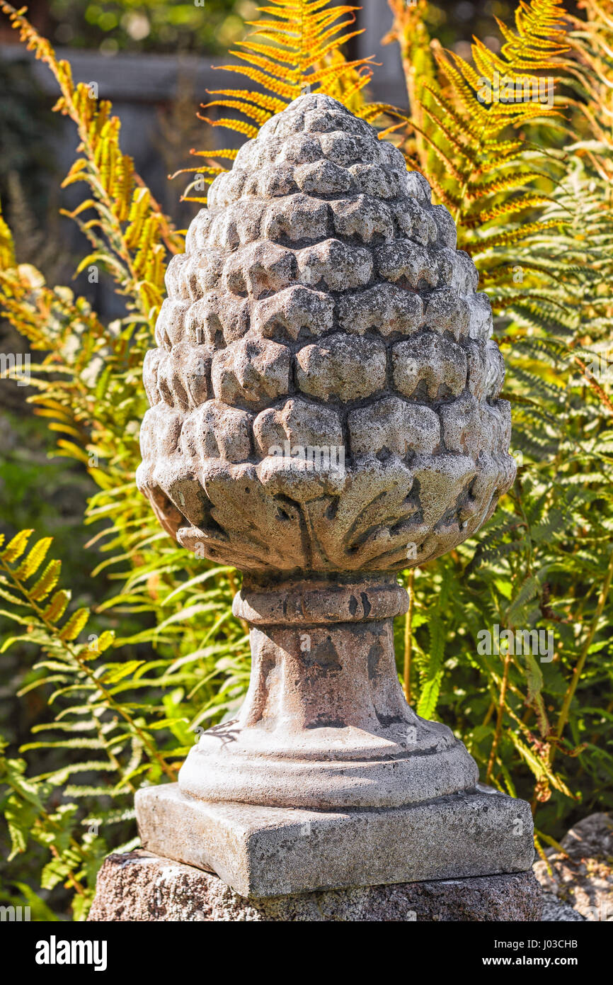 Pine cone shape garden ornament made of stone Stock Photo