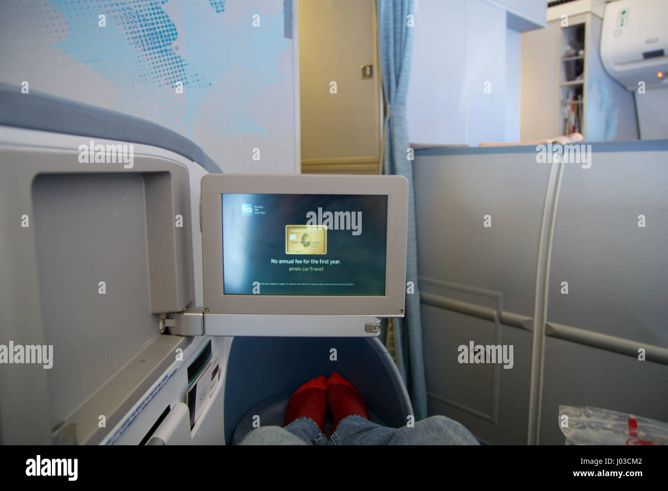 TORONTO, CANADA - JAN 21st, 2017: Air Canada Business class seat inside a Air Canada Airbus A330 on my way from Munich to Toronto. Watching a movie on the personal Inflight Entertainment Stock Photo