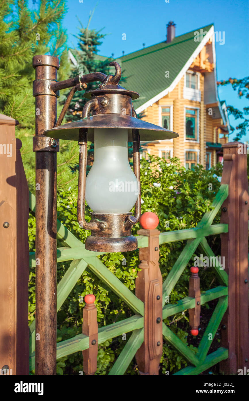 Vintage lantern and wooden fence Stock Photo - Alamy