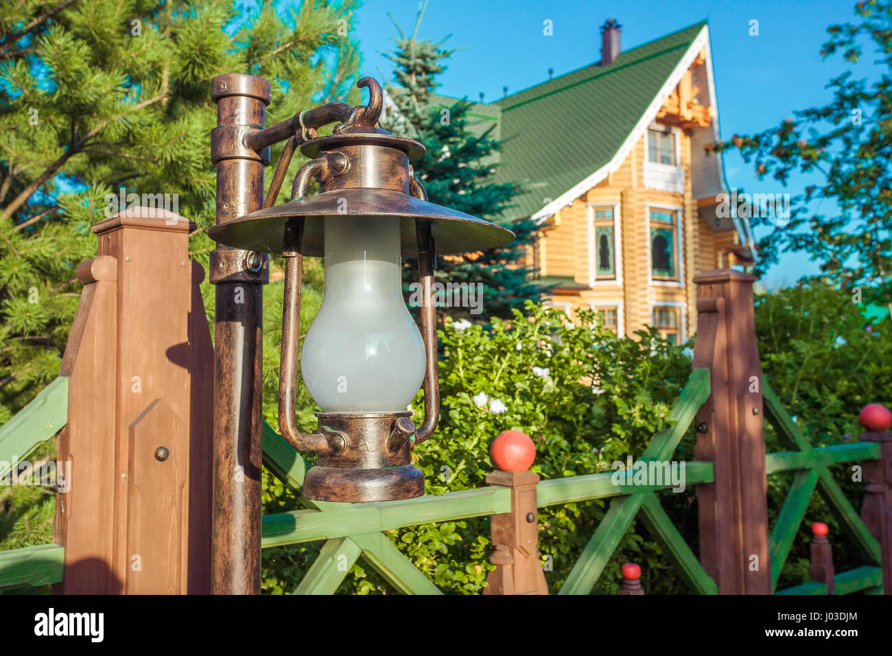 Vintage lantern and wooden fence Stock Photo - Alamy