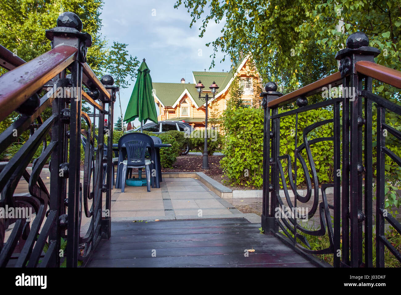 Plastic table, chairs and umbrella on terrace Stock Photo Alamy
