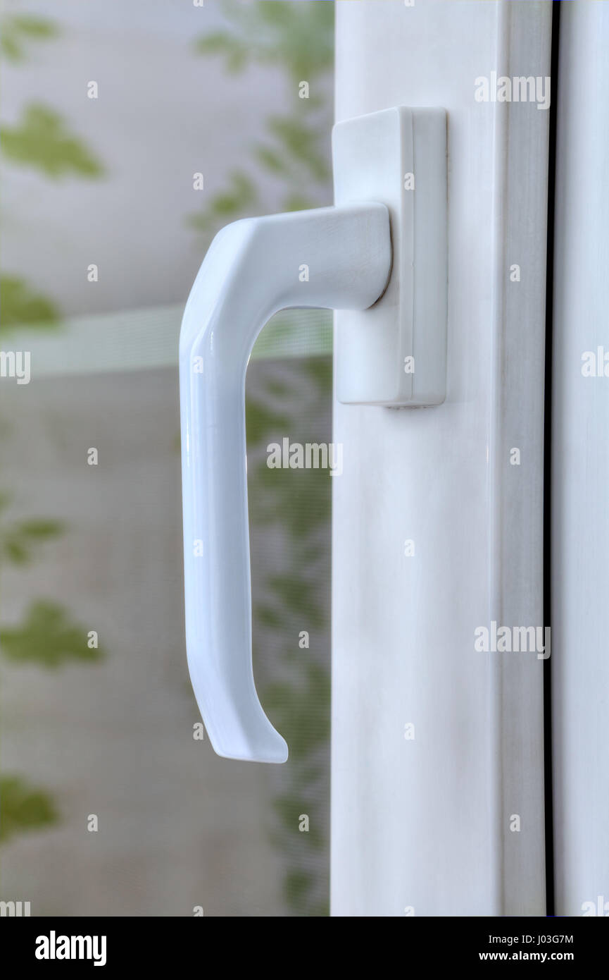 Closeup handle of the pvc window locking mechanism with double glazing