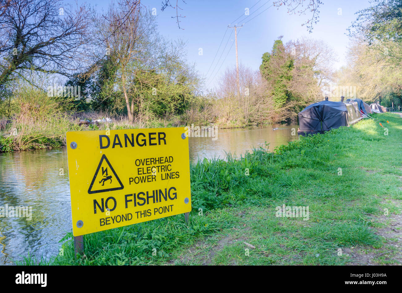 A sign indicating that no fishing is allowed on a section of The river Kennet because of overhead power lines. Stock Photo