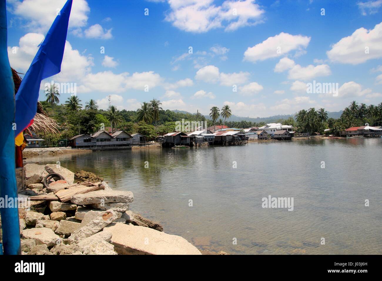 Fishing village, Barangay Lianga, Surigao del Sur, Philippines Houses on the seaside, some on stilts are built directly above the water. Stock Photo