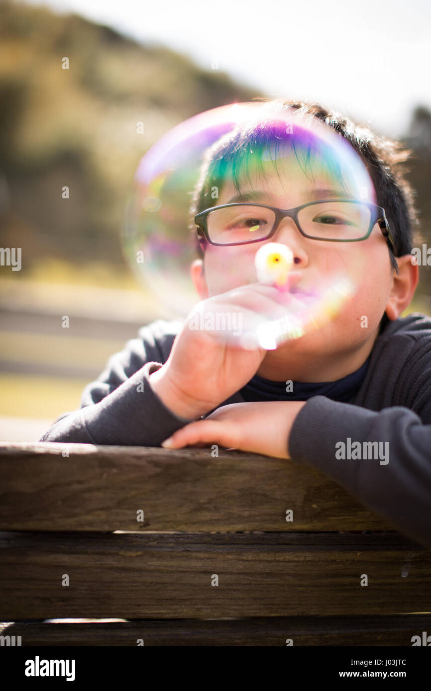 Playing soap bubble in the park Stock Photo - Alamy