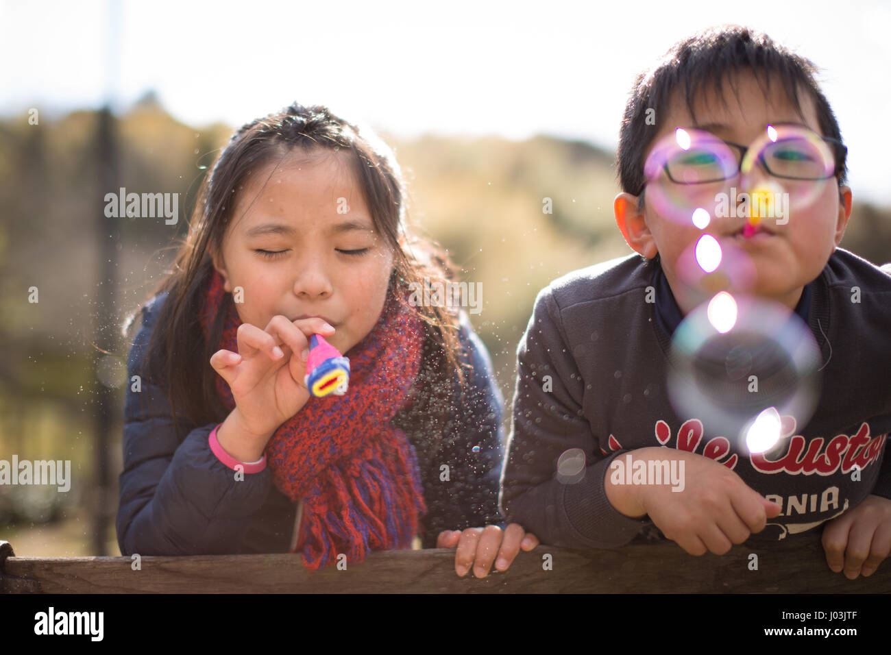 Playing soap bubble in the park Stock Photo - Alamy