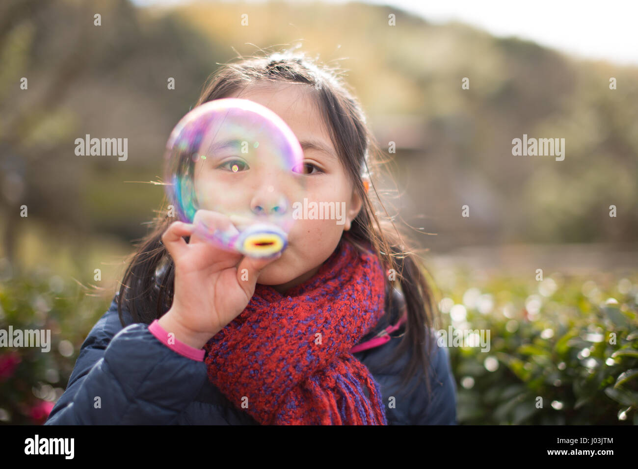 Playing soap bubble in the park Stock Photo - Alamy