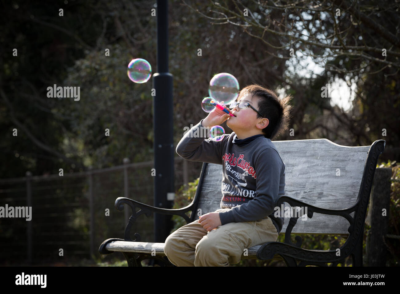 Playing soap bubble in the park Stock Photo - Alamy