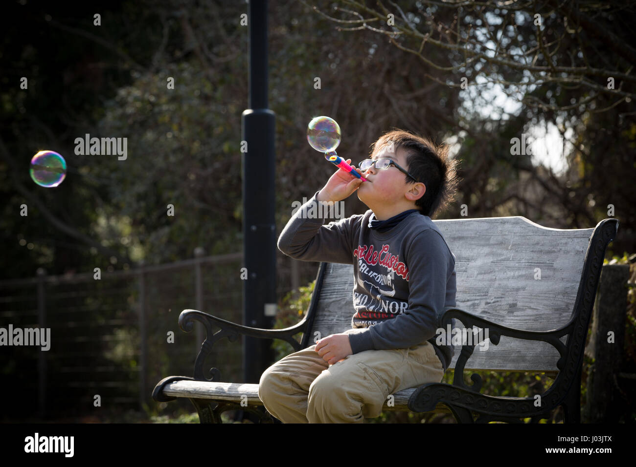 Playing soap bubble in the park Stock Photo - Alamy