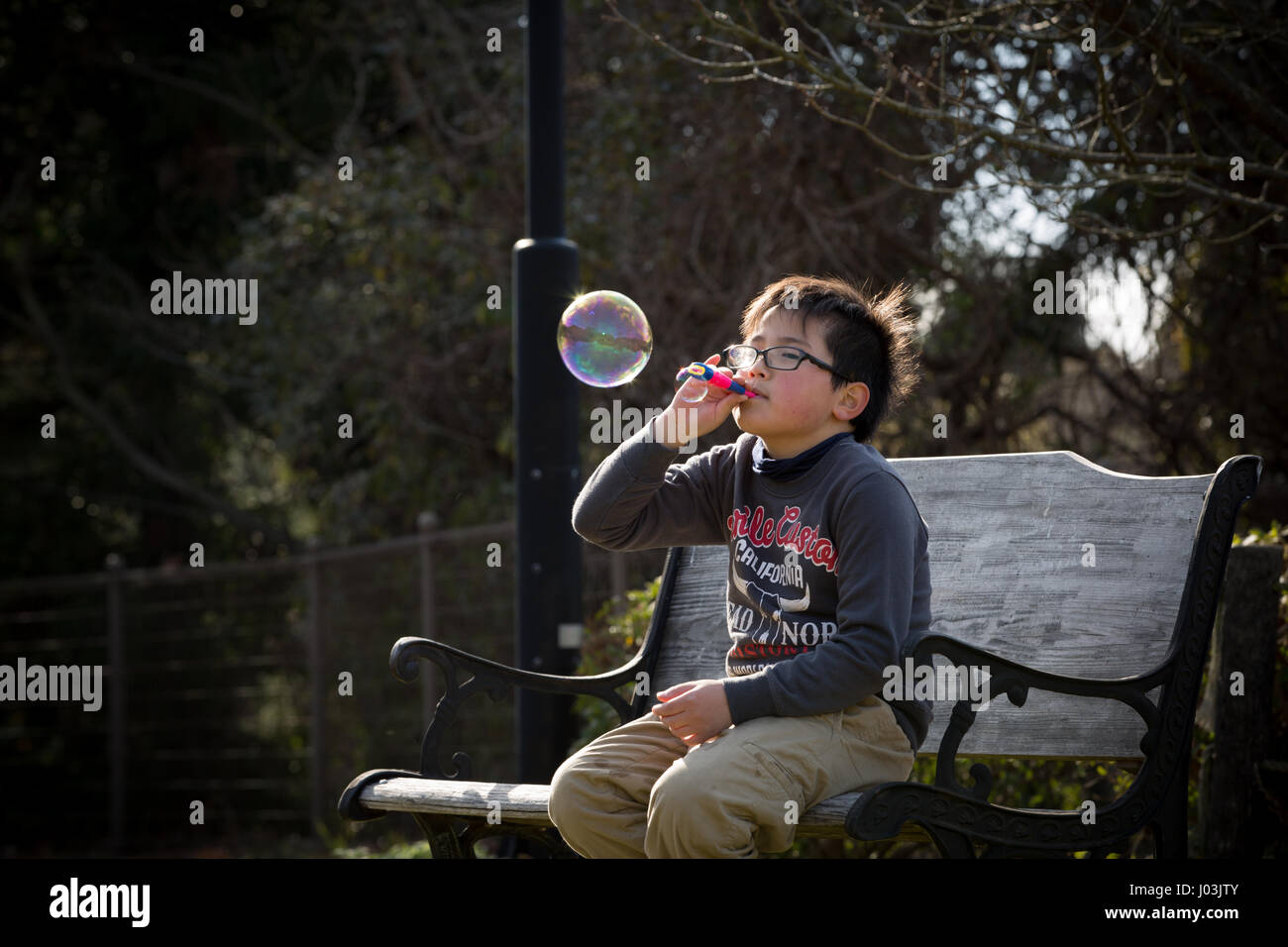 Playing soap bubble in the park Stock Photo - Alamy
