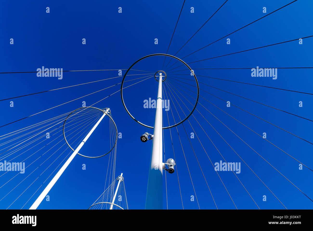 Abstract architecture, metallic posts with strings against blue sky, unusual low angle view Stock Photo
