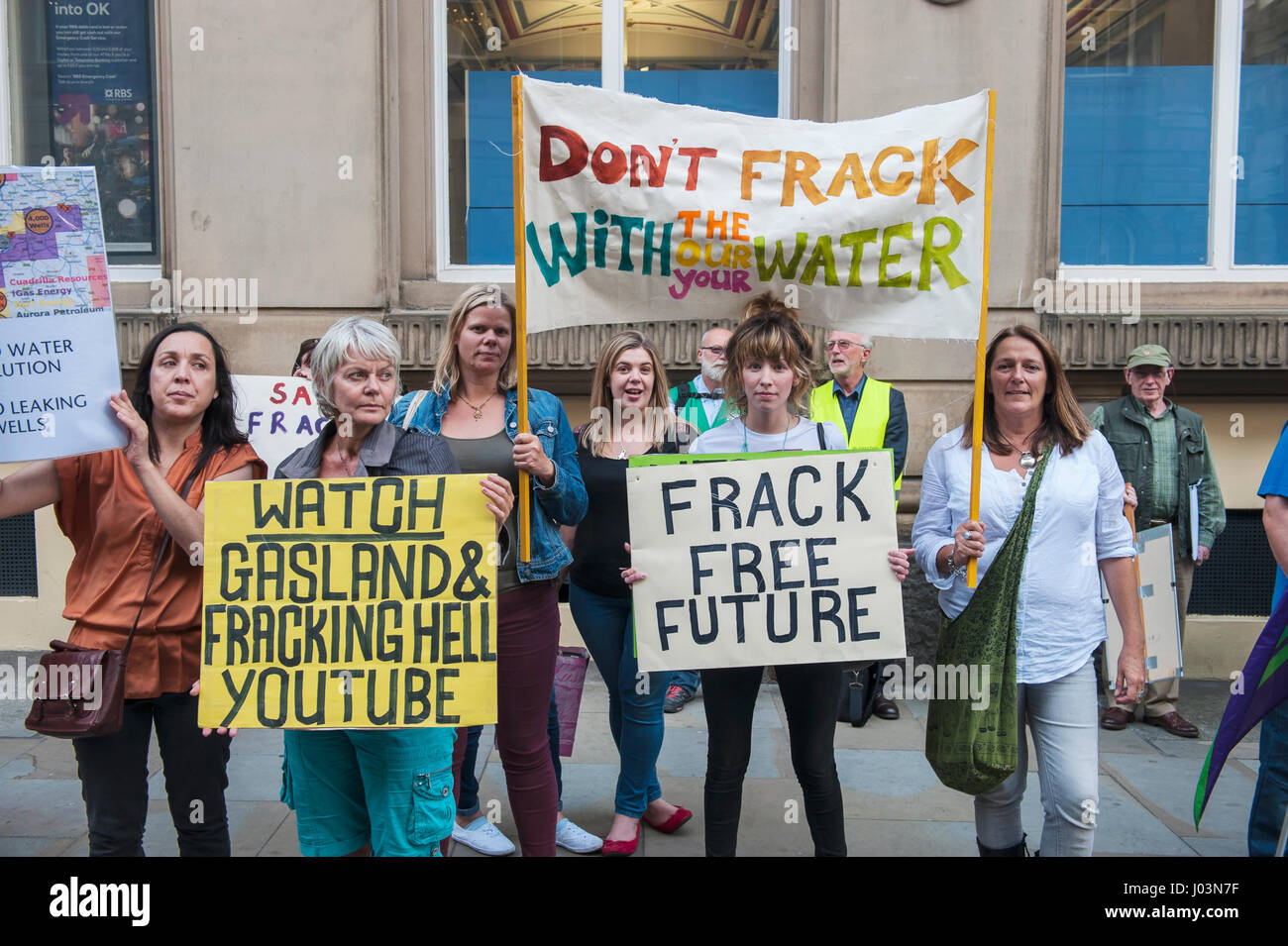 Anti-fracking campaigners stand outside Liverpool Town Hall while local campaigner hands a petition against fracking to the council Stock Photo