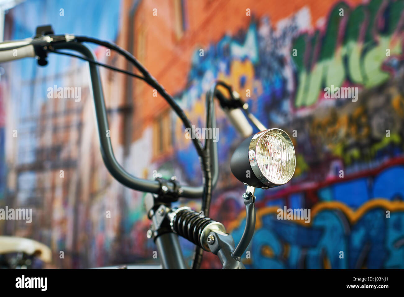 Headlight custom bike closeup on graffiti background Stock Photo