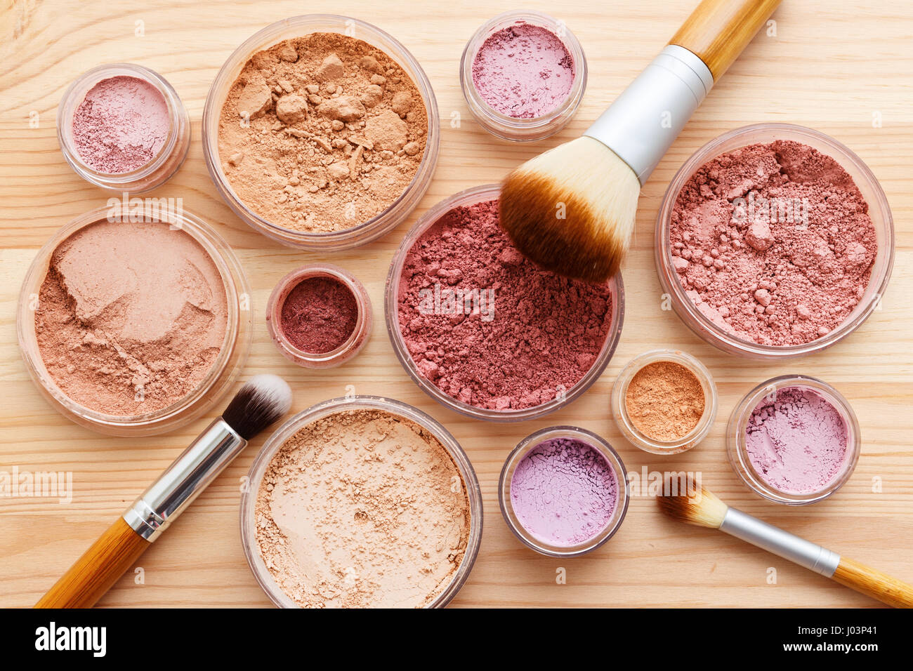 Makeup powder products with foundation blush eye shadow and brush flat lay Stock Photo