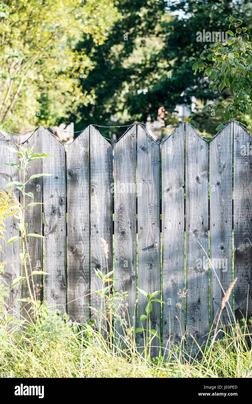 old wooden fence with barbed wire on top Stock Photo - Alamy