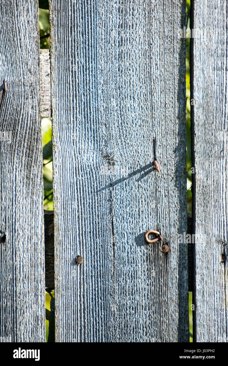old wooden fence with barbed wire on top Stock Photo - Alamy