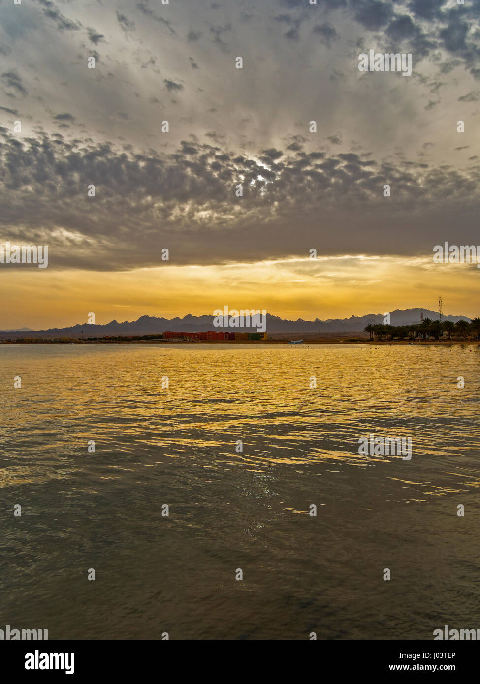 The setting sun adds a golden reflection to the Red Sea Stock Photo - Alamy