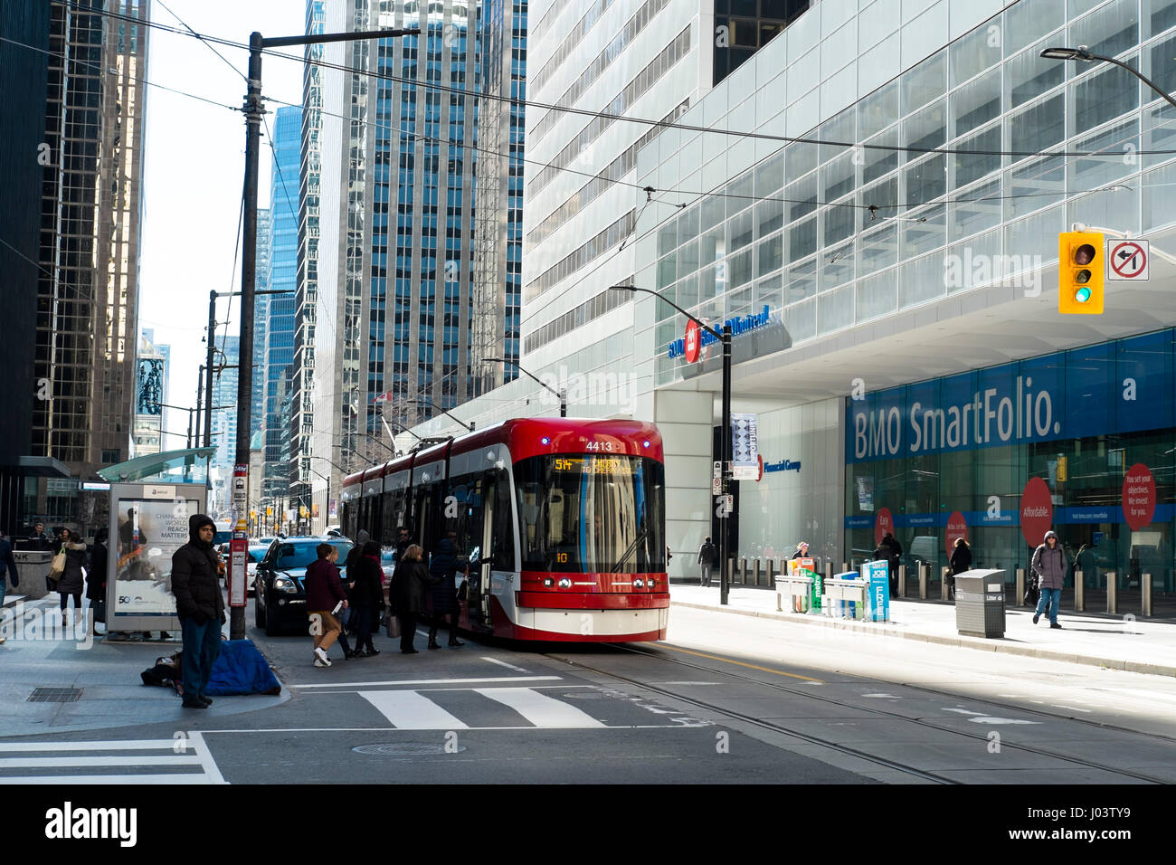Street scene with tram passing BMO bank building in the Toronto Financial District, Ontario, Canada Stock Photo
