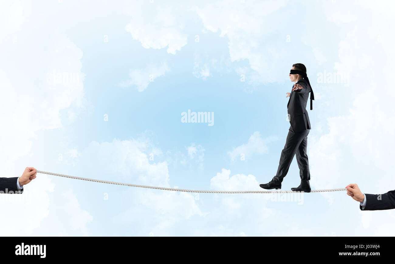 Business concept of risk support and assistance with man balancing on ...