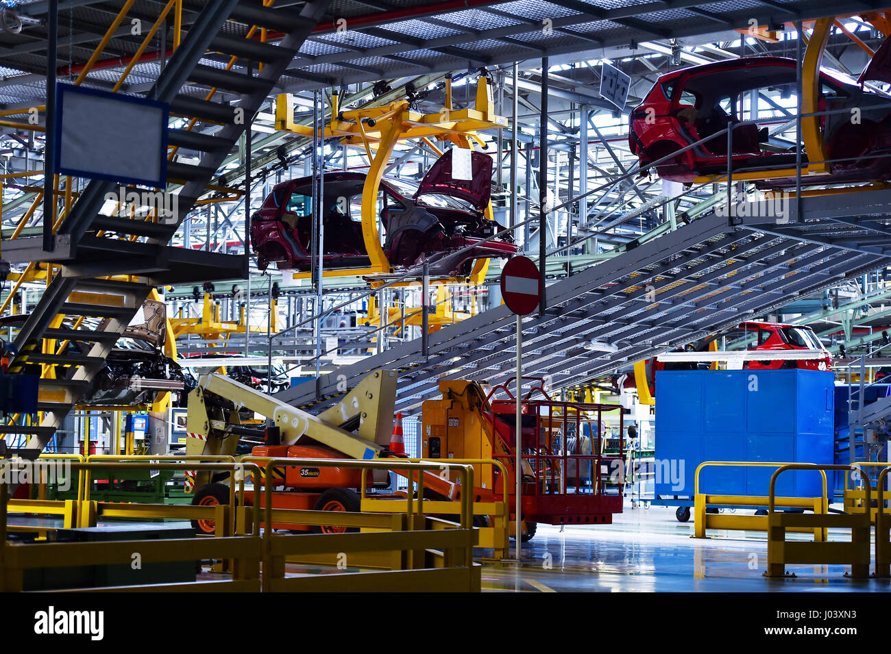 Car bodies on the production line inside automobile factory Stock Photo