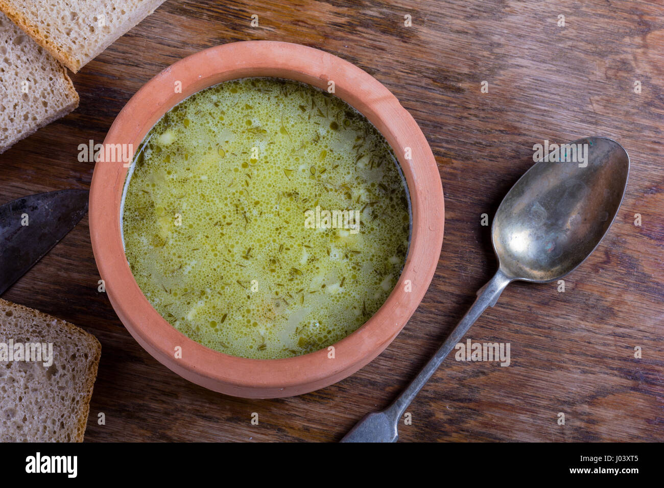 Traditional Polish sour gherkin soup served in a clay bowl Stock Photo