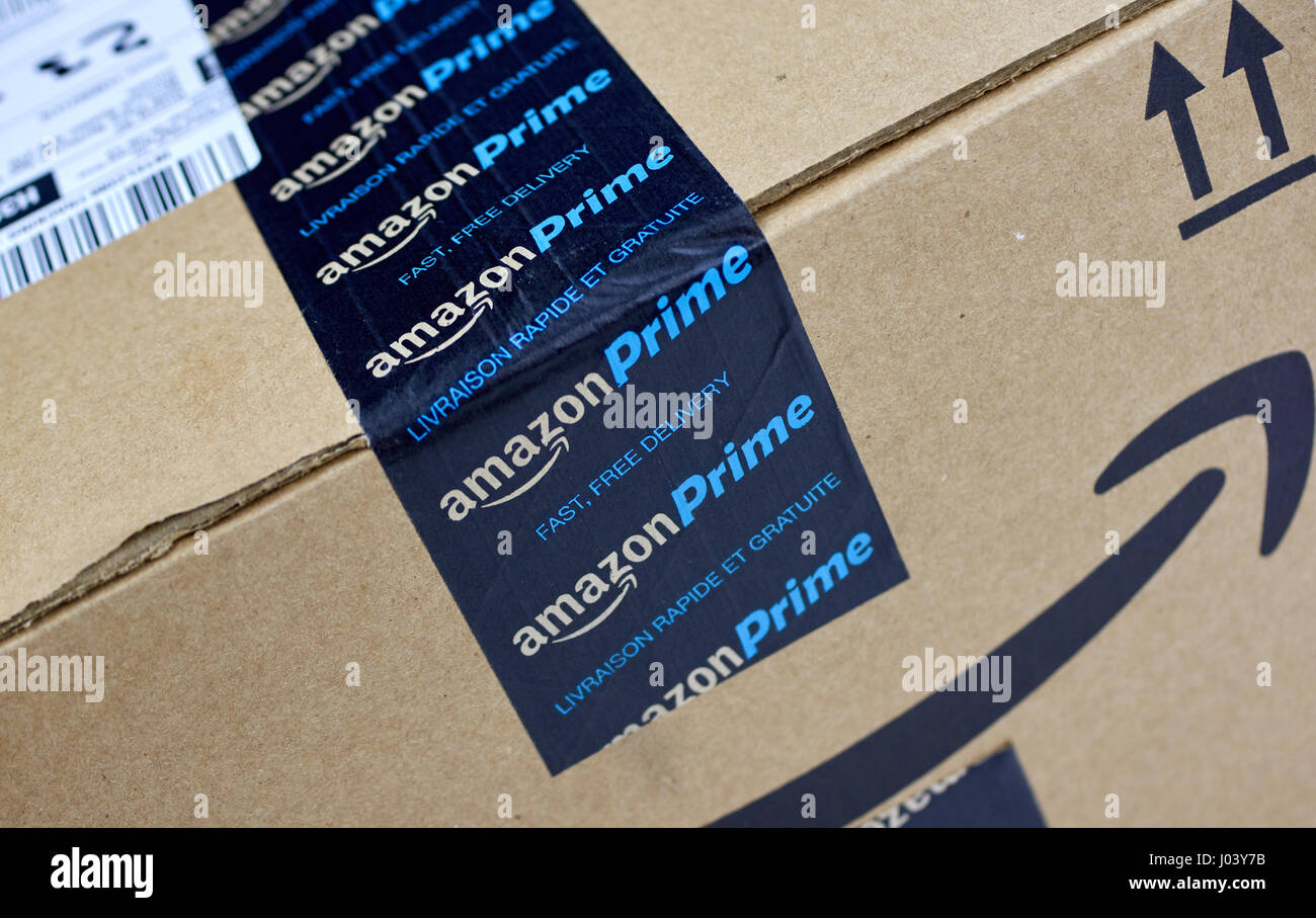 MONTREAL, CANADA - MARCH 28, 2017: Amazon Prime shipping box with branded tape on it. Amazon is an American electronic commerce and cloud computing co Stock Photo