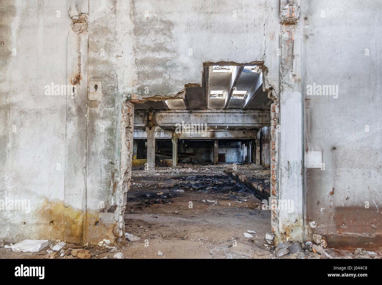 Interior of old factory buildings destroyed. Ruins of industrial enterprise abandoned. Empty space. Stock Photo