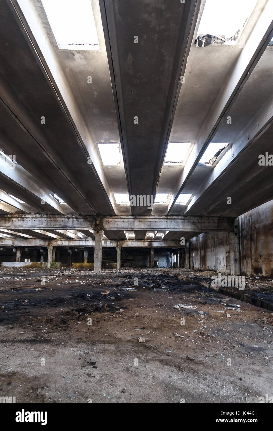 Interior of old factory buildings destroyed. Ruins of industrial enterprise abandoned. Empty space. Stock Photo