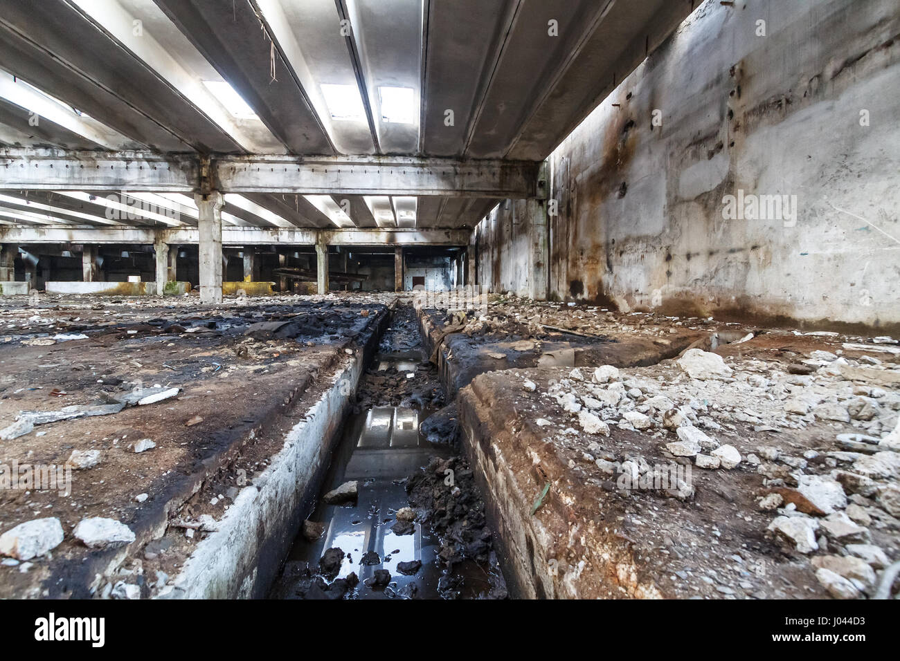 Interior of old factory buildings destroyed. Ruins of industrial enterprise abandoned. Empty space. Stock Photo