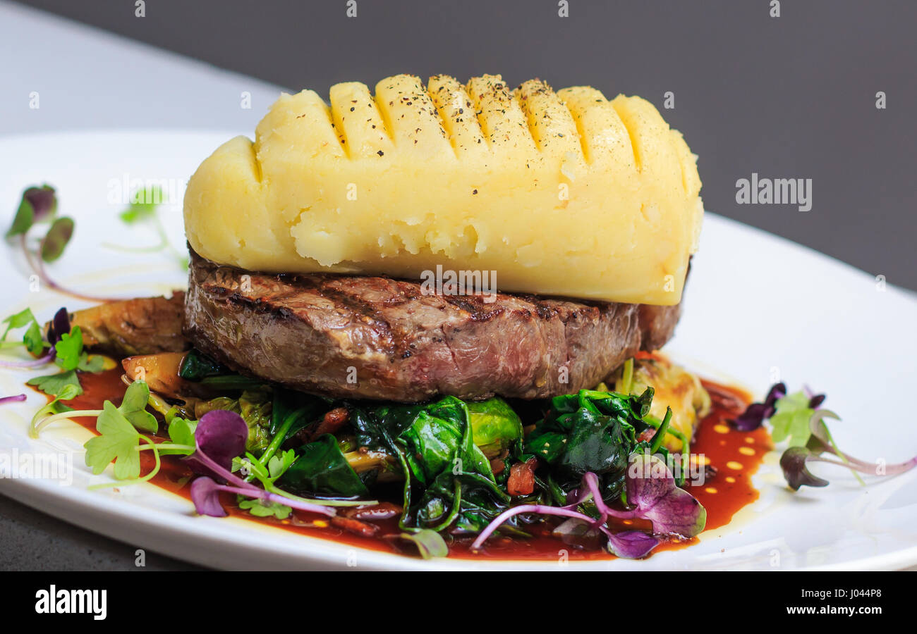 Grass Fed scotch fillet with mustard mash, brussels sprouts, red wine jus, micro herbs, Stock Photo