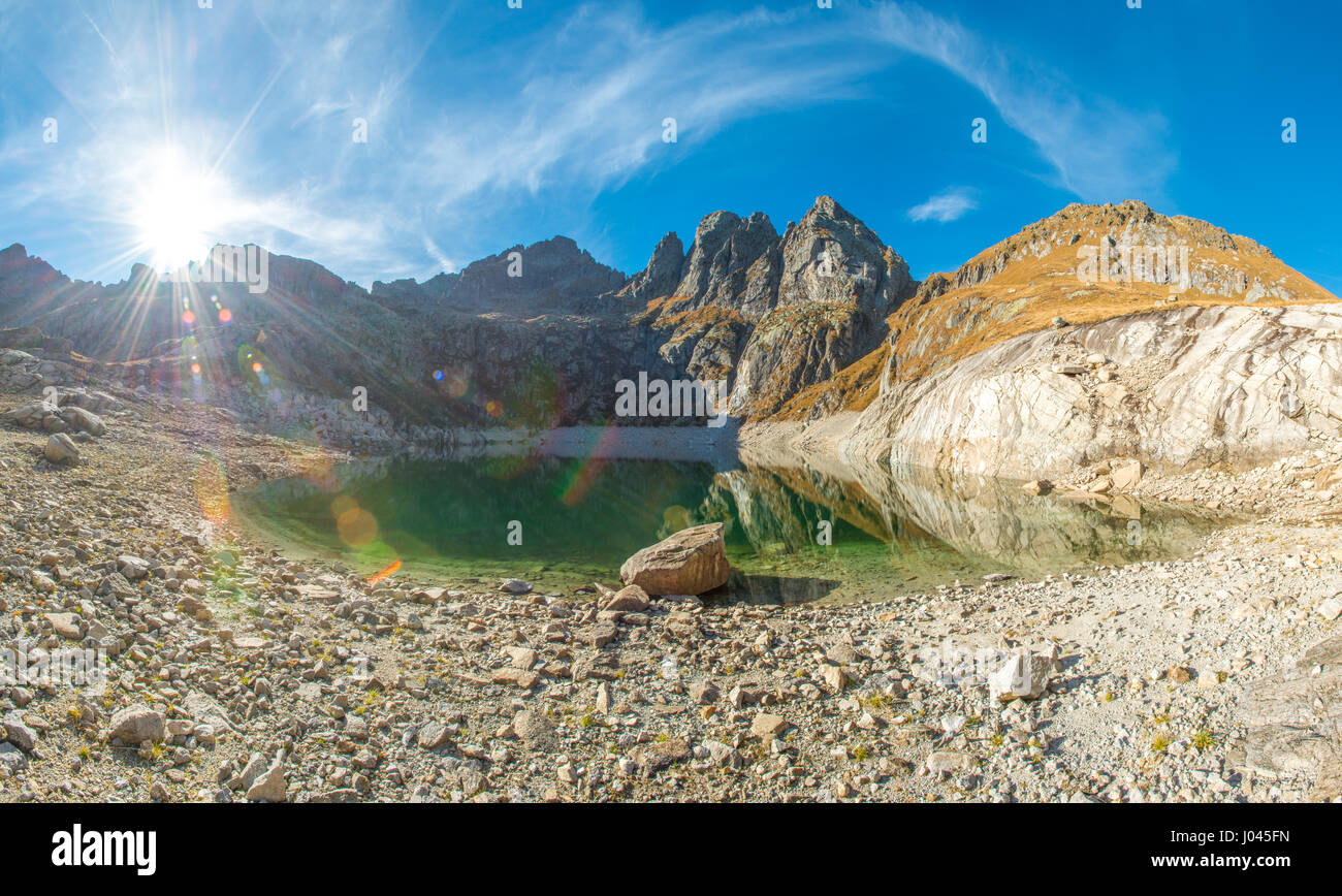 The Italian Alps shine in the sun - lake reflections Stock Photo