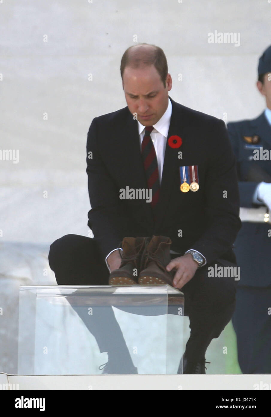 The Duke of Cambridge lays boots and a poppies of remembrance at Vimy Memorial Park in France, during commemorations for the 100th anniversary of the Battle of Vimy Ridge. Stock Photo