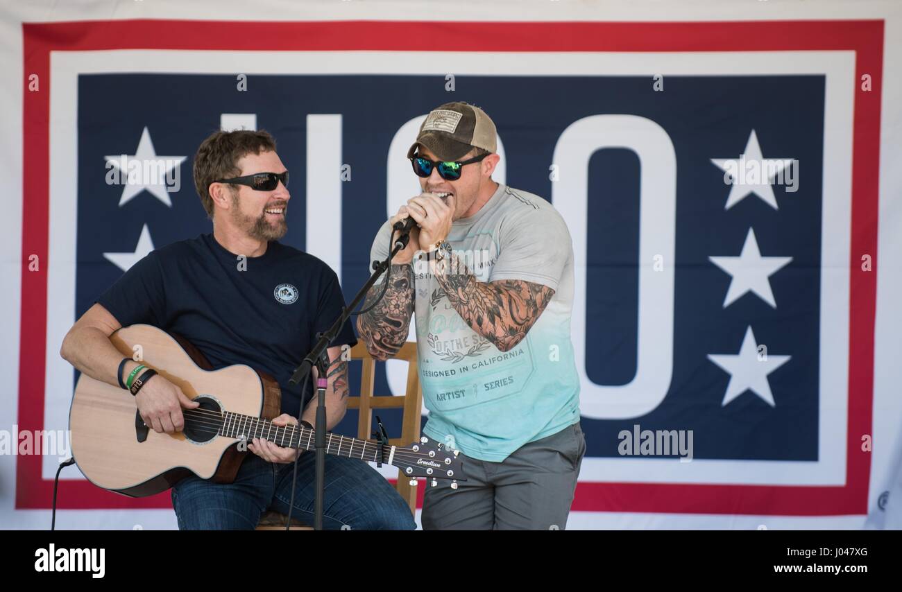 A U.S. sailor sings along with country music singer Craig Morgan during a USO show at the Joint Base Pearl Harbor-Hickam March 25, 2017 in Pearl Harbor, Hawaii.      (photo by James K. McCann /DoD via Planetpix) Stock Photo