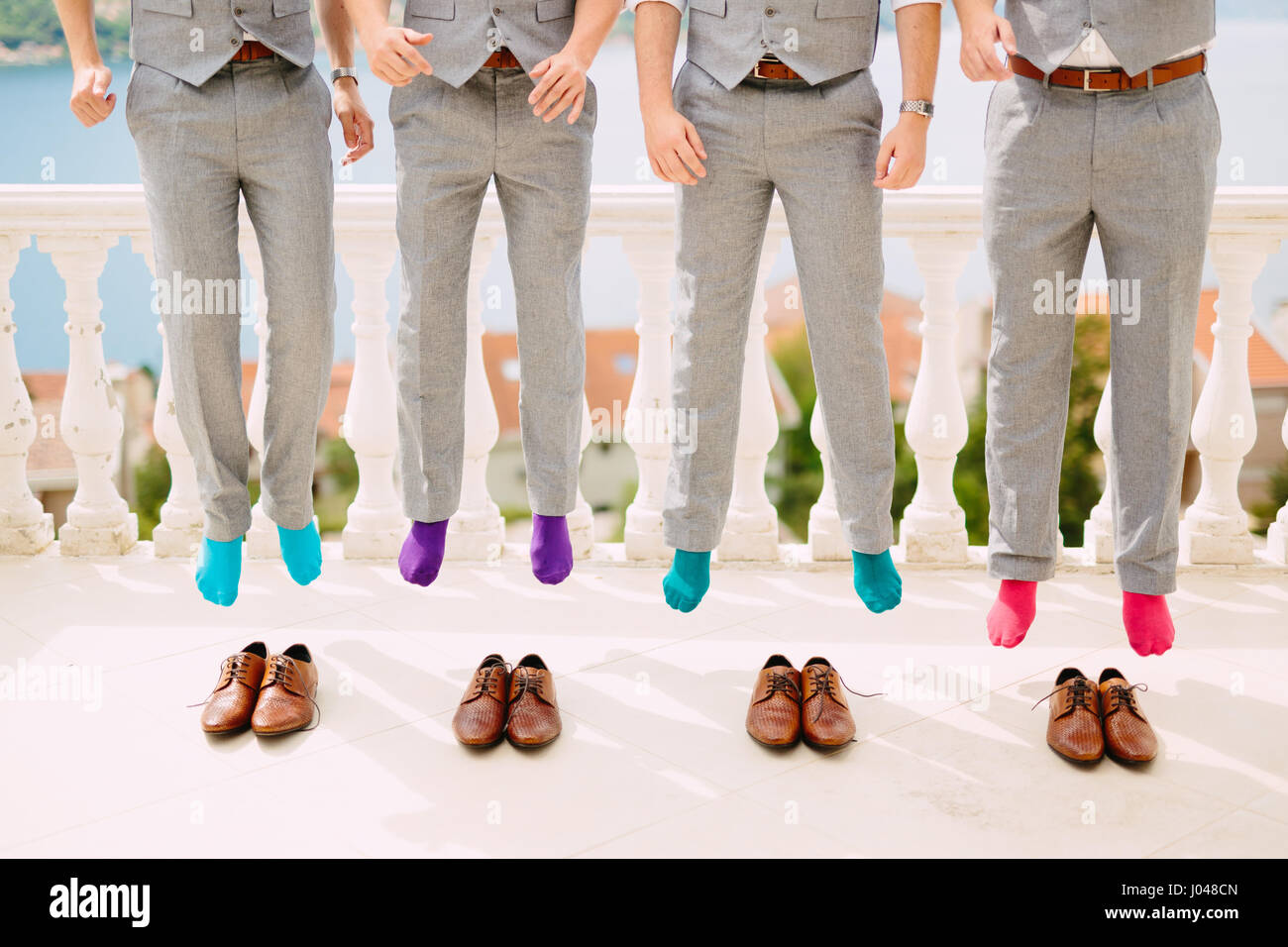 Men in colorful socks. Funny wedding photos. Wedding in Montenegro. Stock Photo
