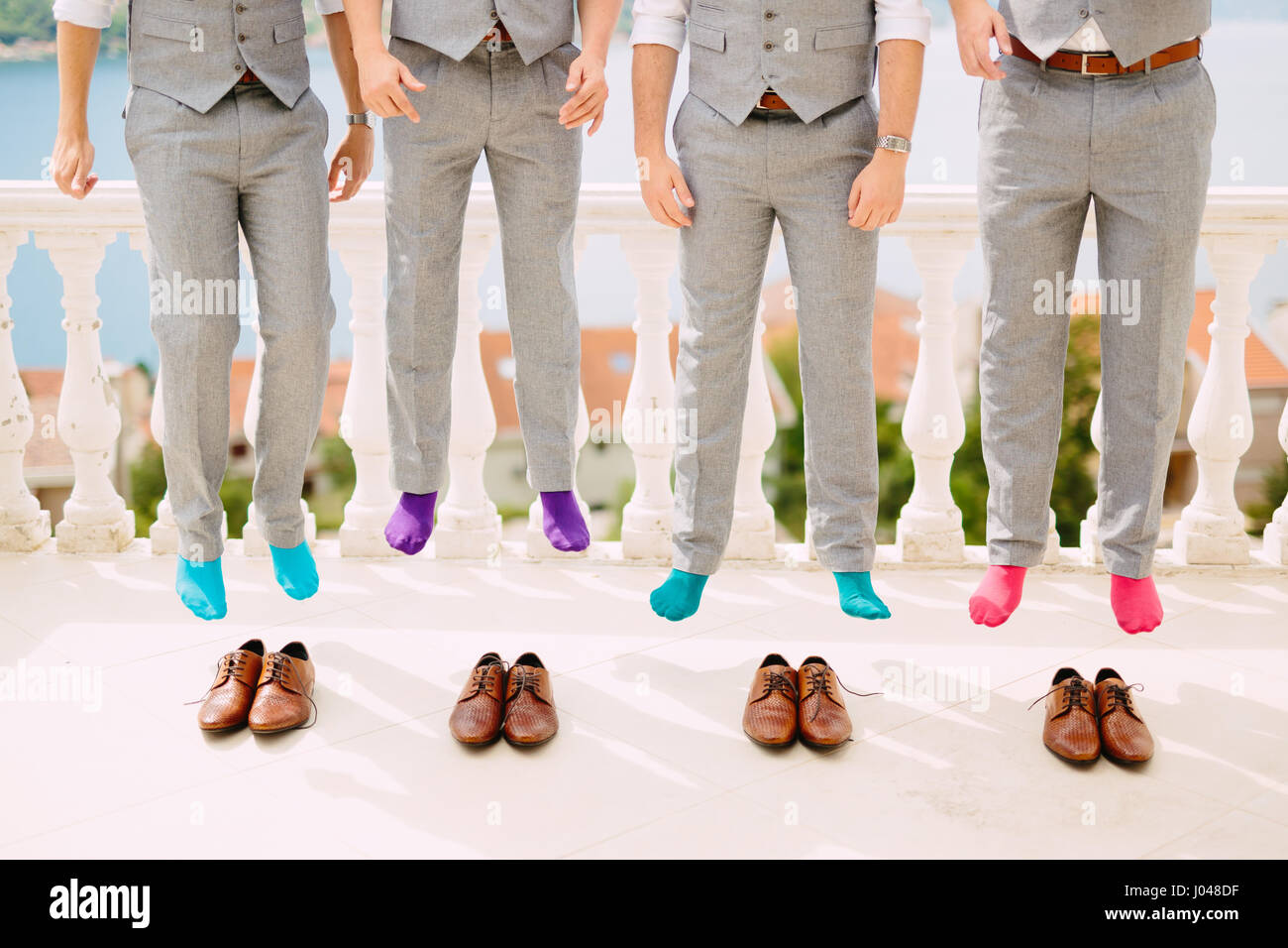 Men in colorful socks. Funny wedding photos. Wedding in Montenegro. Stock Photo