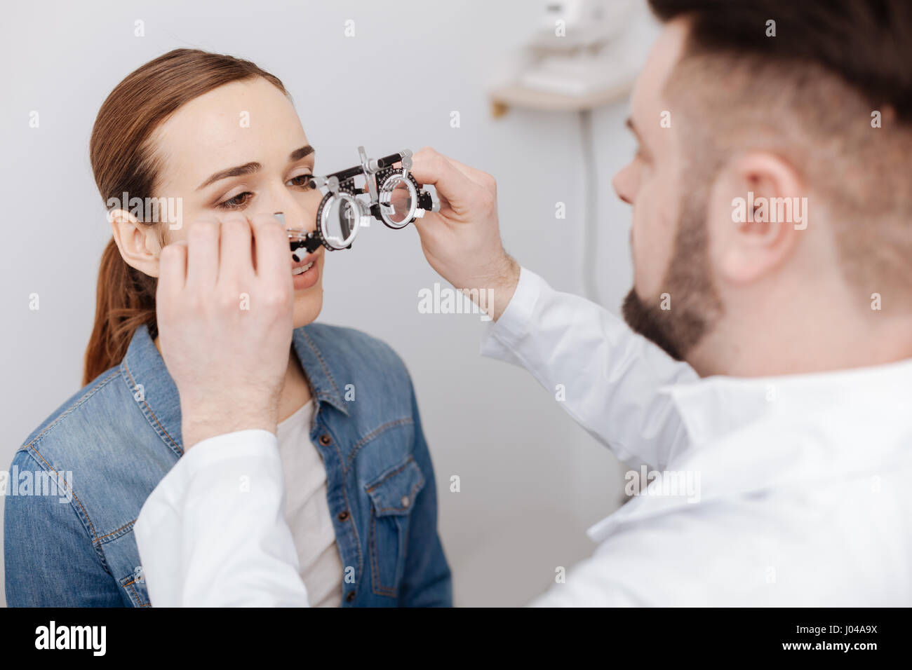 Professional male ophthalmologist preparing to do an eye test Stock