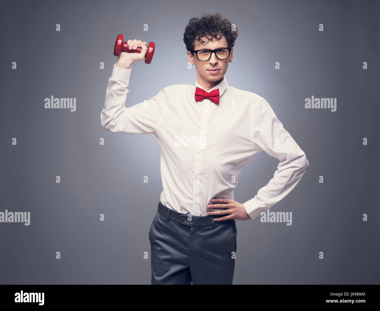 Funny skinny man lifting weights and look proud about it Stock Photo Alamy