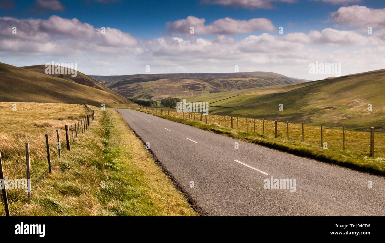 A road runs through sheep pastures in the Moorfoot Hills in Scotland's Southern Uplands. Stock Photo