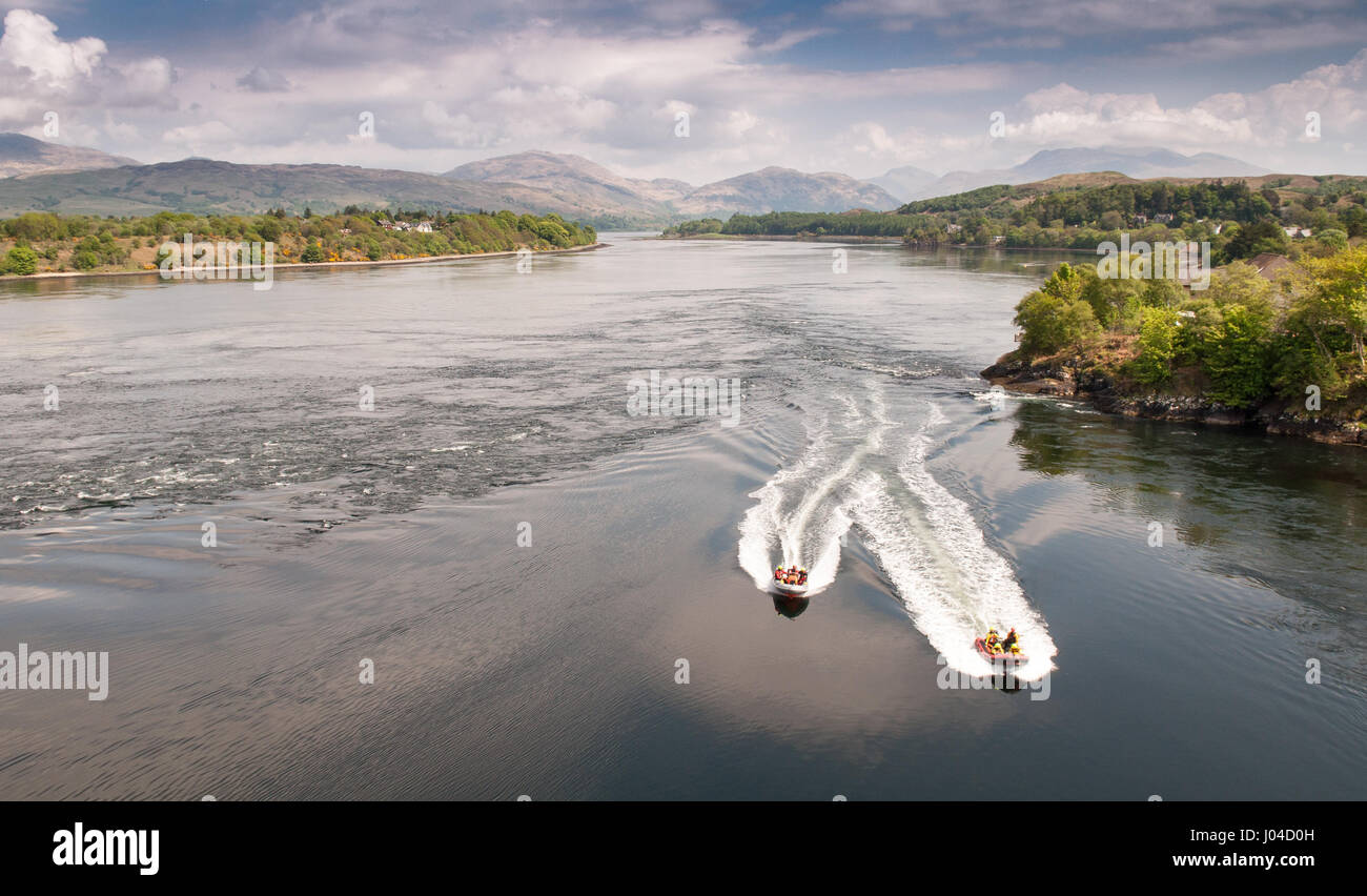Oban, Scotland, UK - May 23, 2010: Boat crews navigate speed boats through the Falls of Lora rapids at the Connel narrows of the sea loch Etive, under Stock Photo