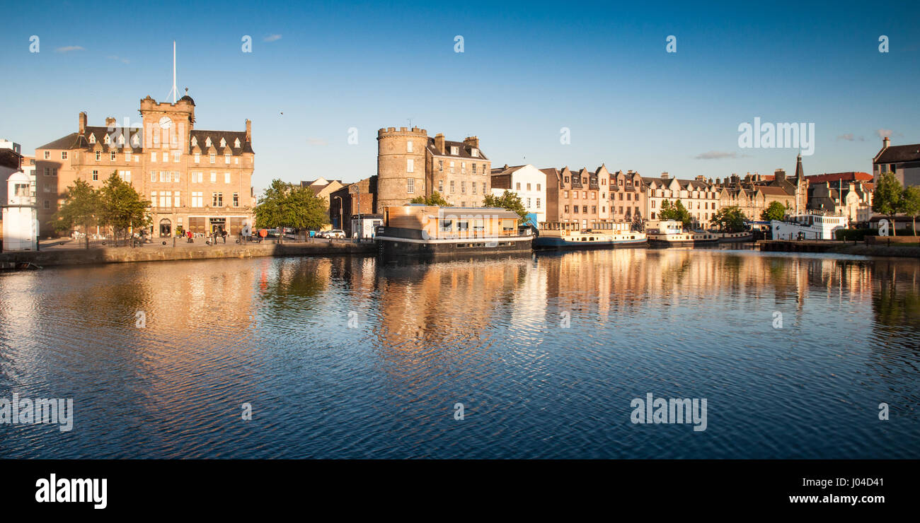 Edinburgh, Scotland, UK - May 30, 2011: Evening sun lights up the historic buildings lining the waterfront of Leith. Stock Photo