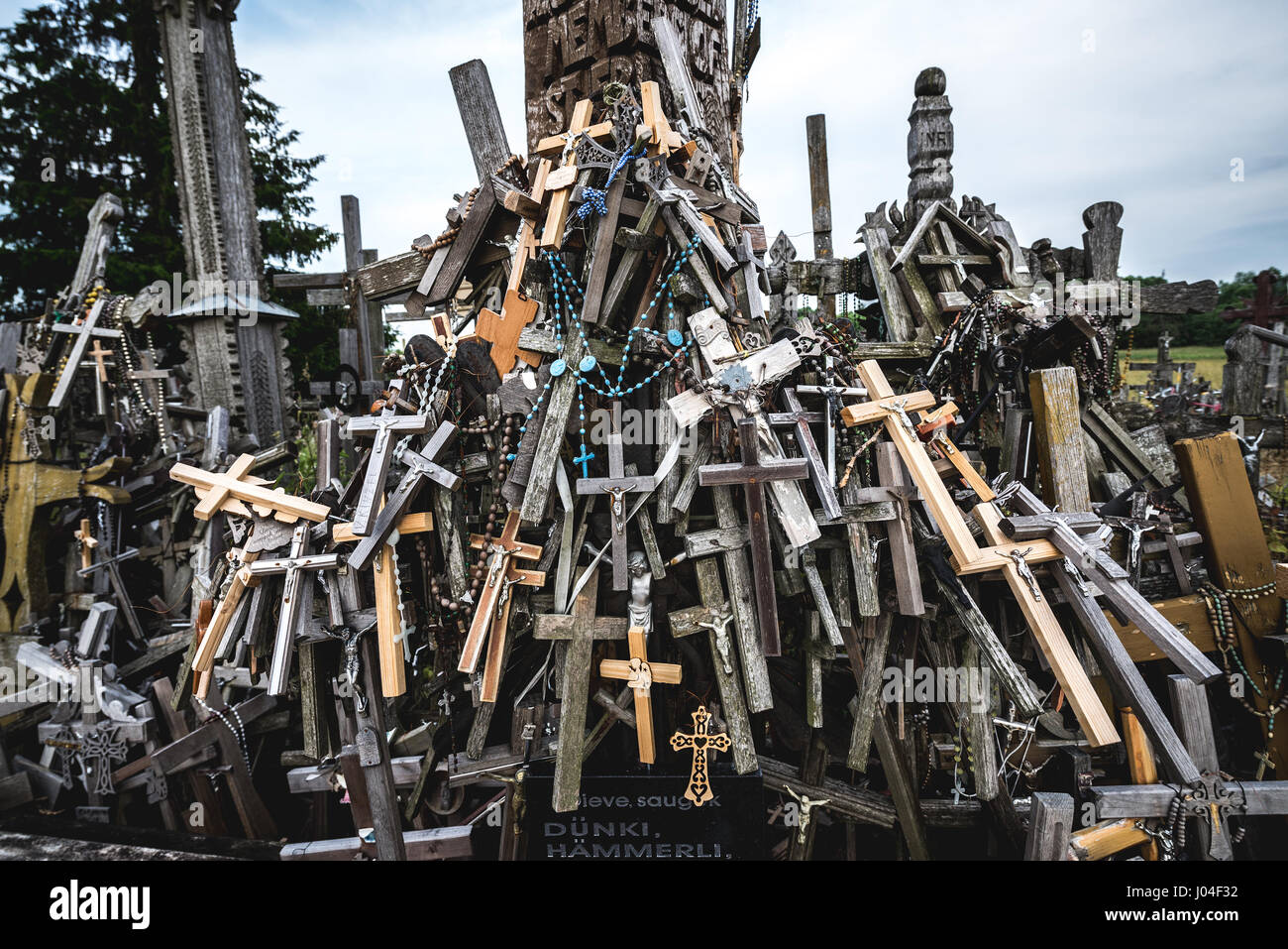 Bunch of small crosses brought by pilgrims on Hill of Crosses in Lithuania Stock Photo
