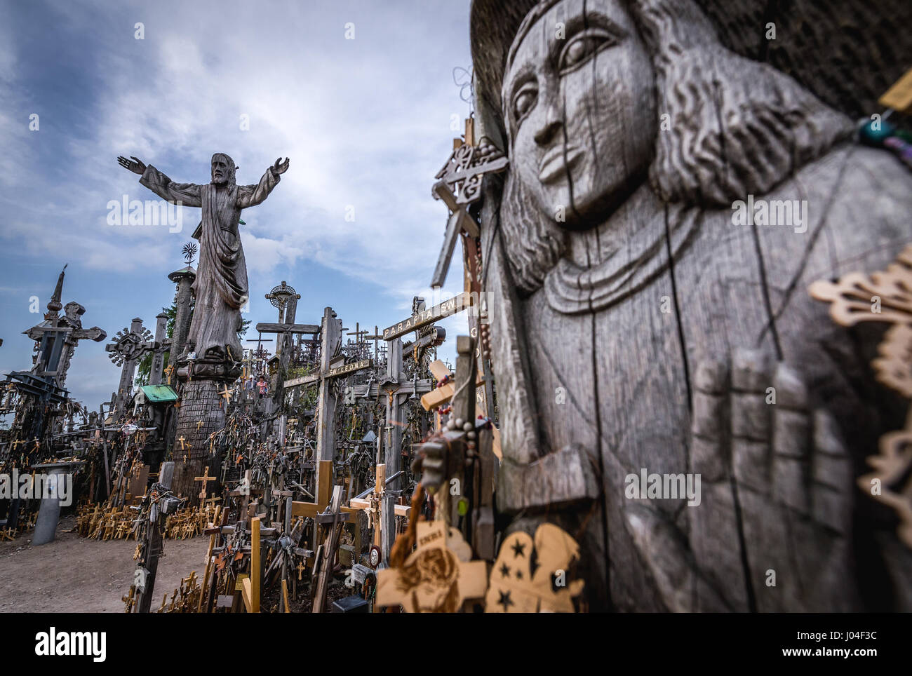 Wooden religious statues on Hill of Crosses in Lithuania Stock Photo