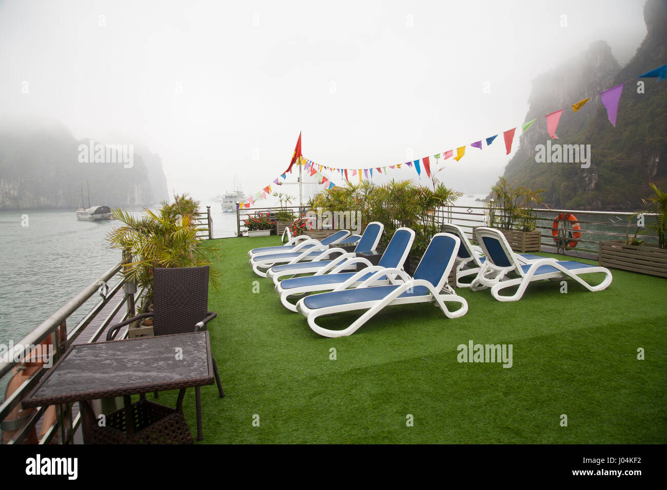 Boat upper deck with blue beach chairs, empty, no people, overlooking